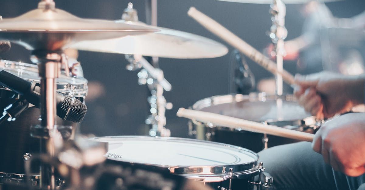 A close up of a person playing drums on a stage.