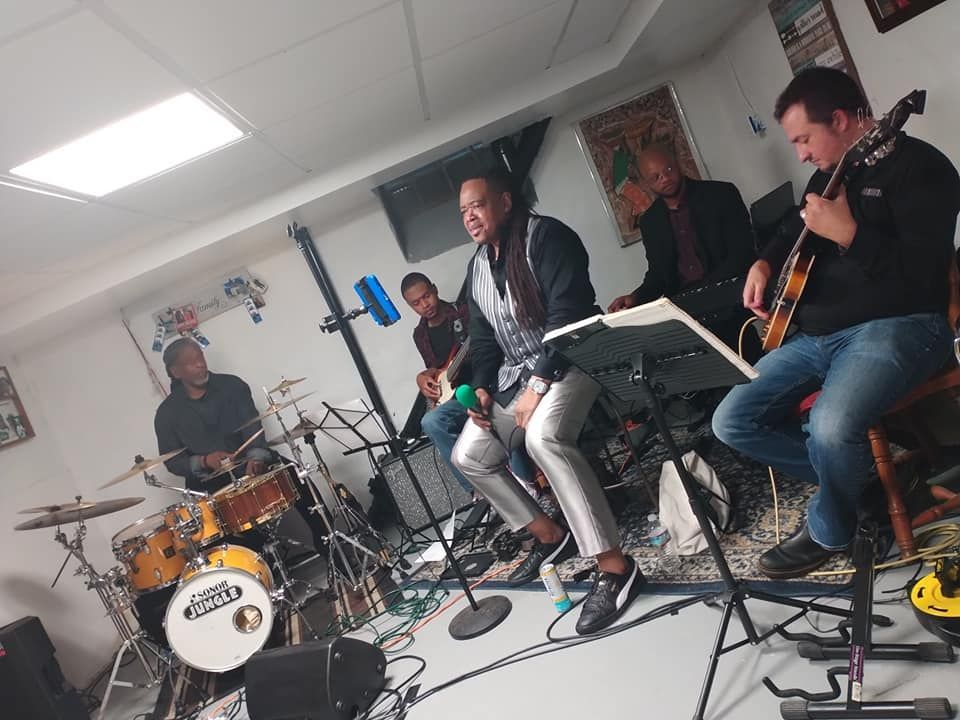 A group of men are playing instruments in a room.