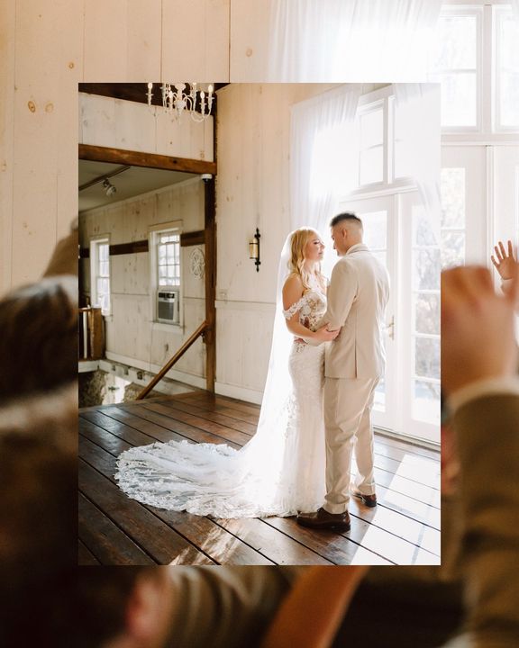 A bride and groom are standing next to each other in a room.
