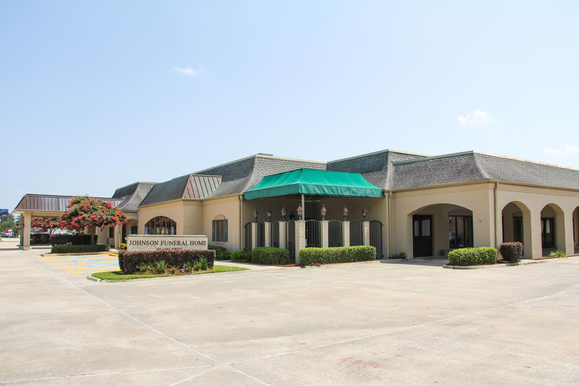 a building with hanging baskets of flowers in front of it .