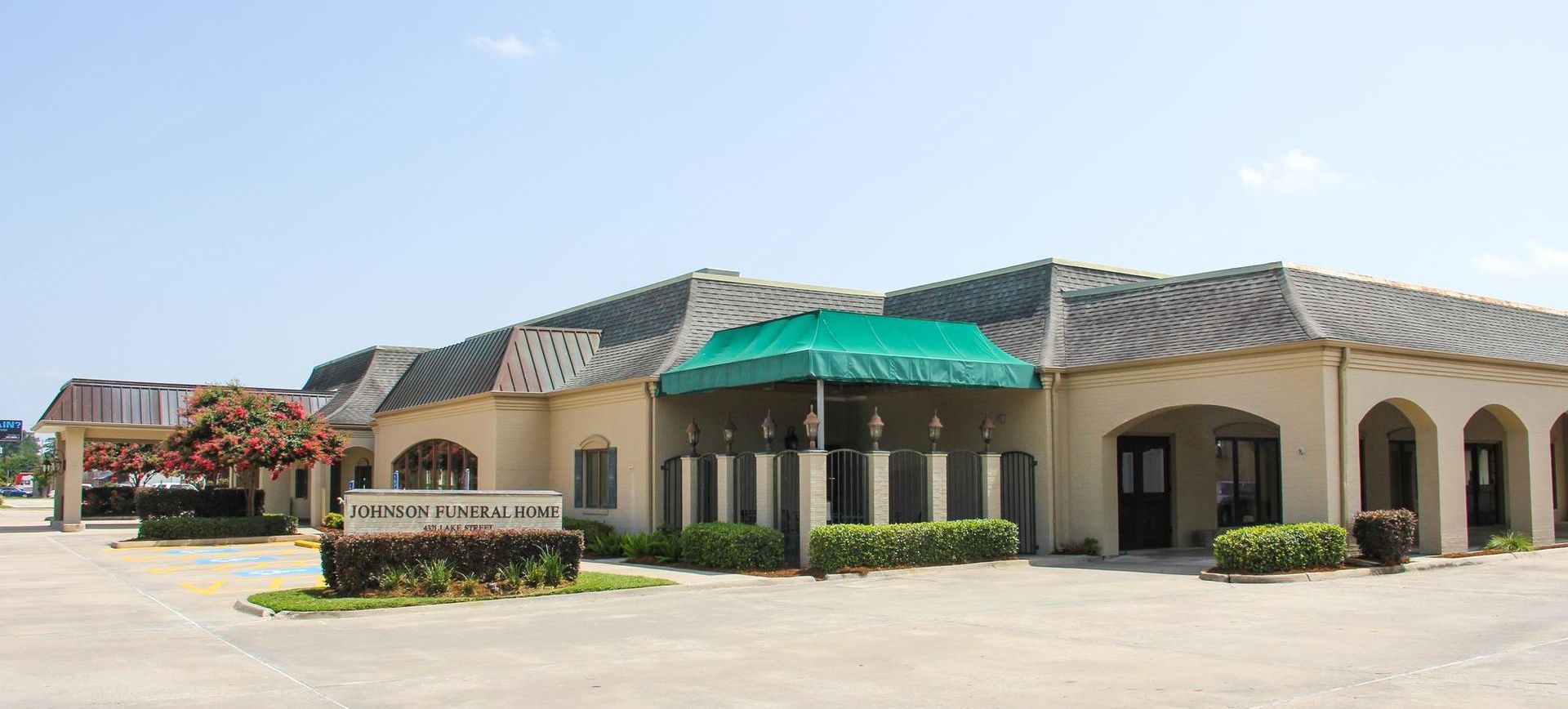 A large building with a green awning over the entrance.