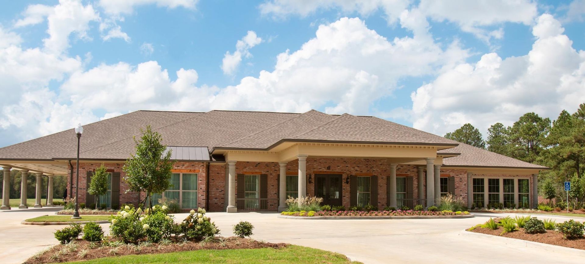 A large brick building with a driveway in front of it