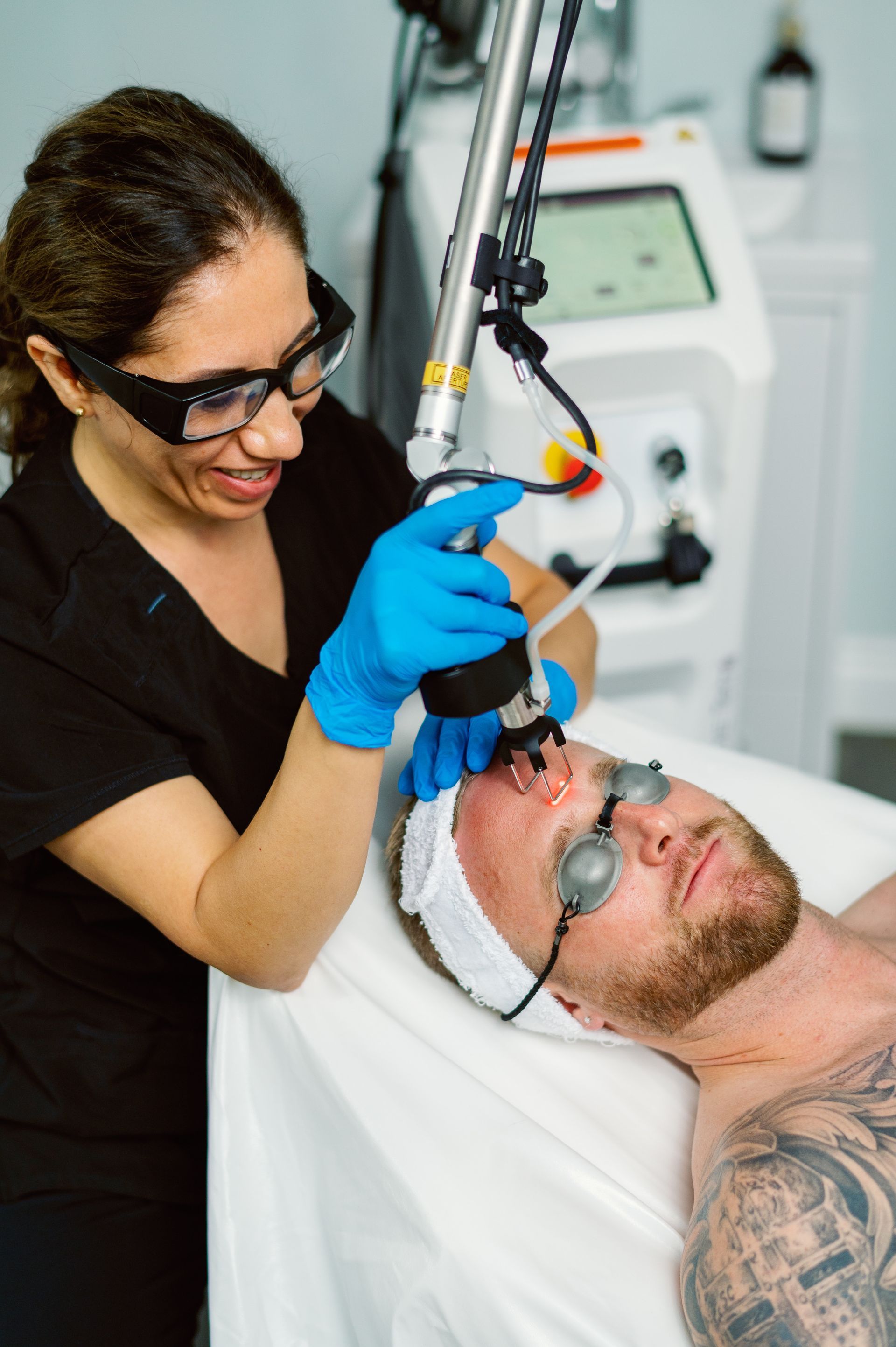 A man is getting a laser treatment on his face.