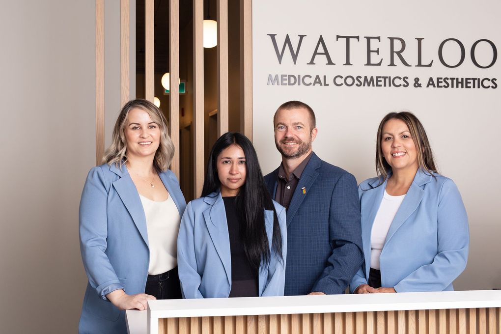 A group of people are posing for a picture in front of a counter.