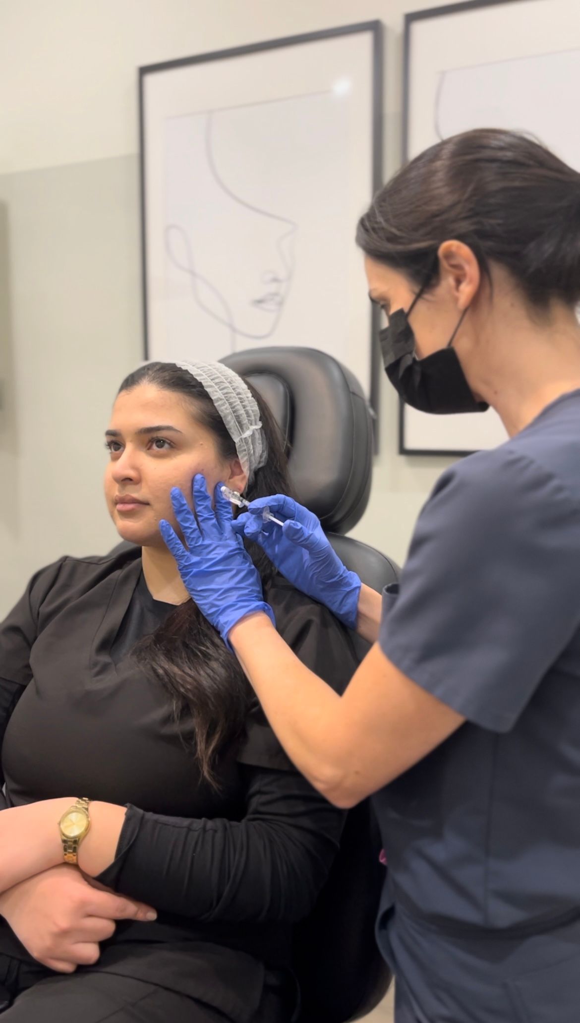A woman is getting a botox injection in her face