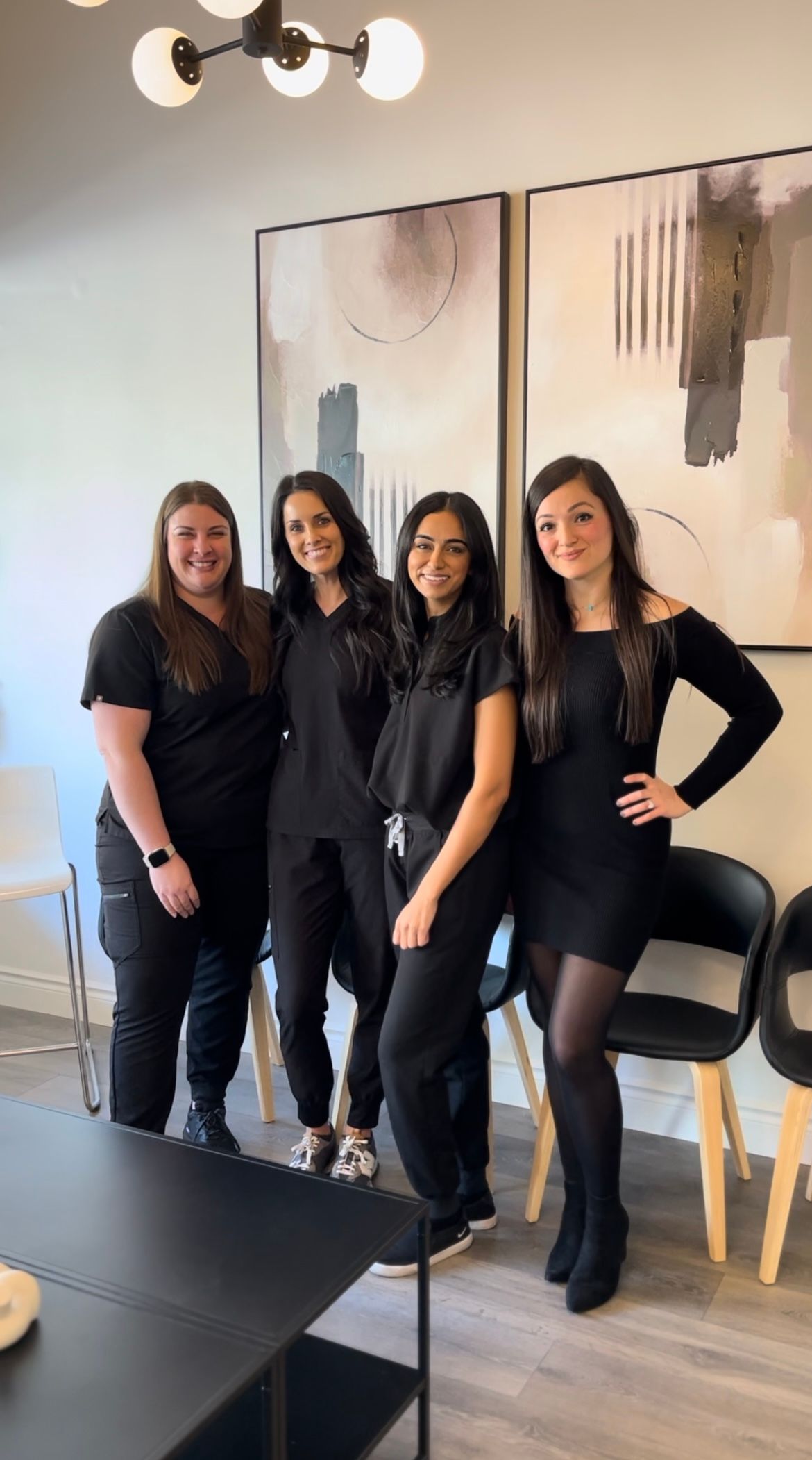 A group of women are posing for a picture in a waiting room.