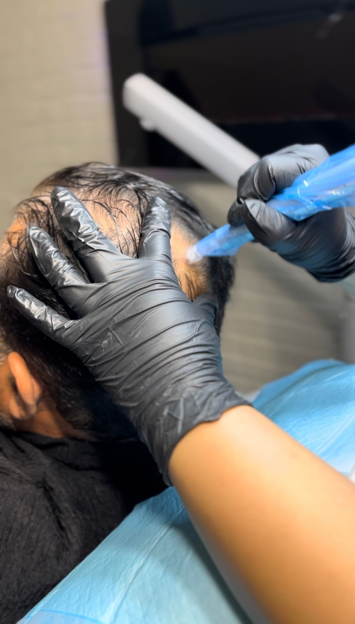 A person is getting a hair treatment in a salon.