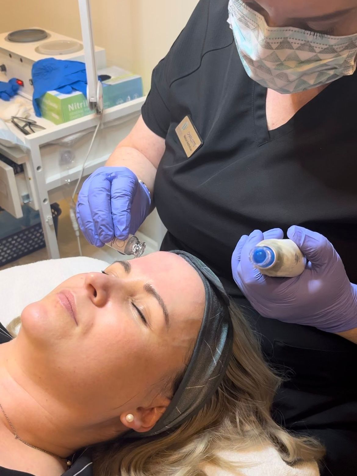 A woman is getting a facial treatment at a beauty salon.