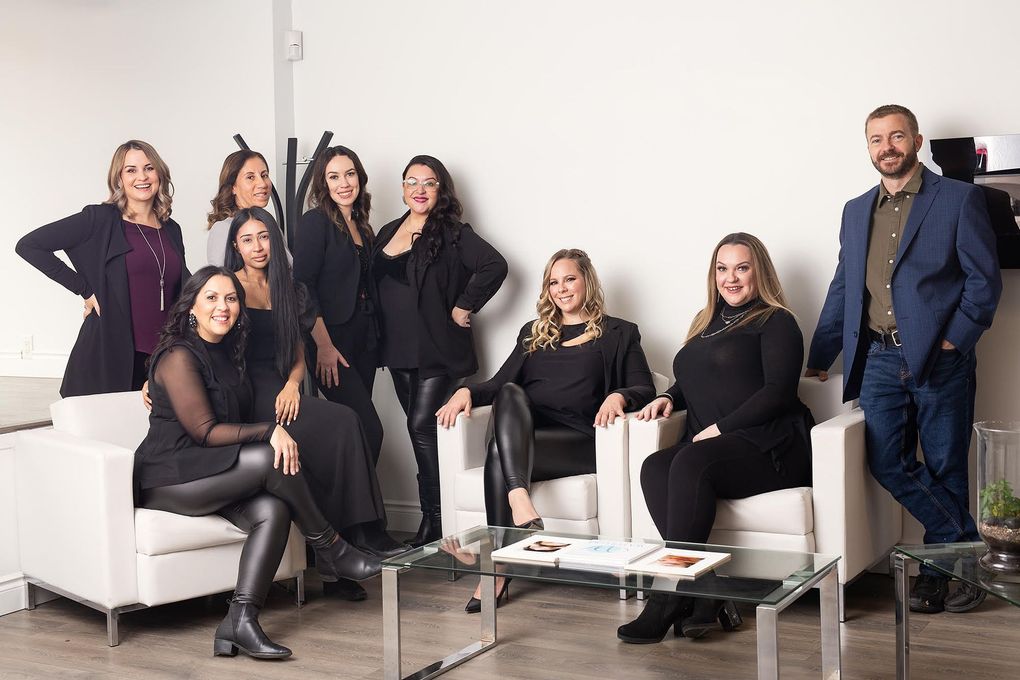 A group of people are posing for a picture in a waiting room.