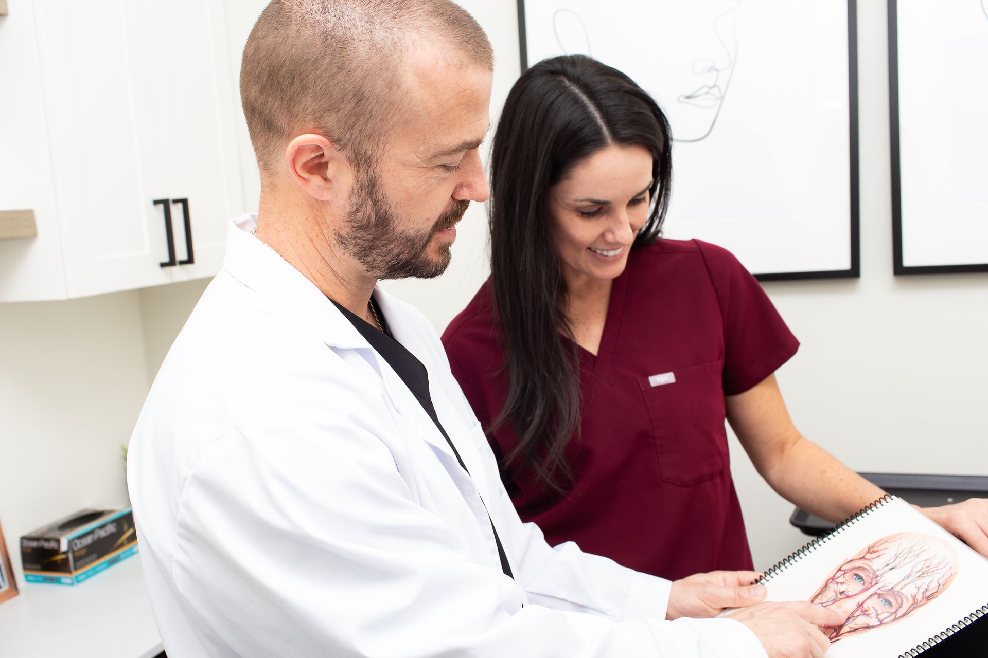 A man and a woman are looking at a picture of a heart.