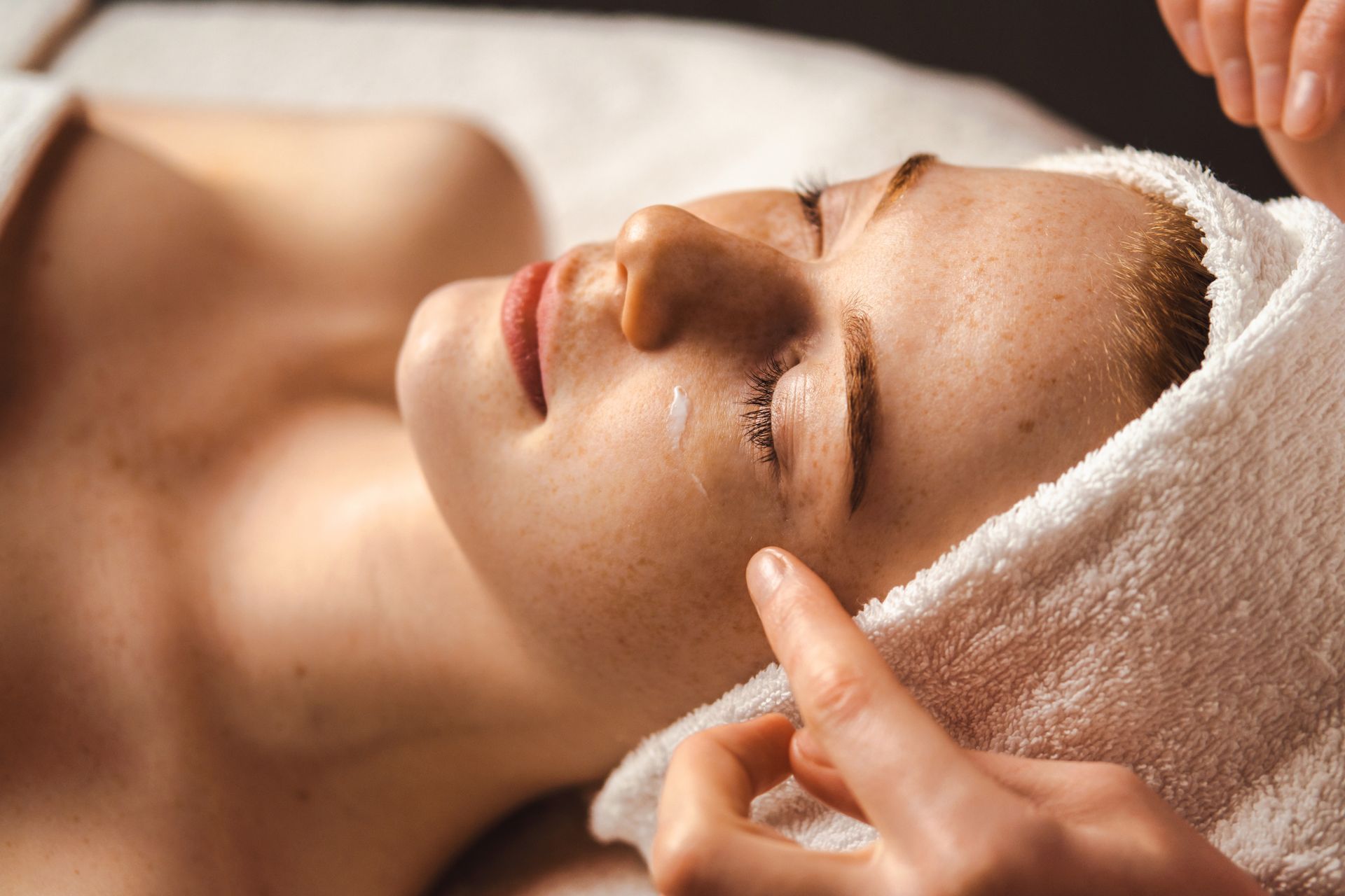 A woman is getting a facial treatment at a spa.