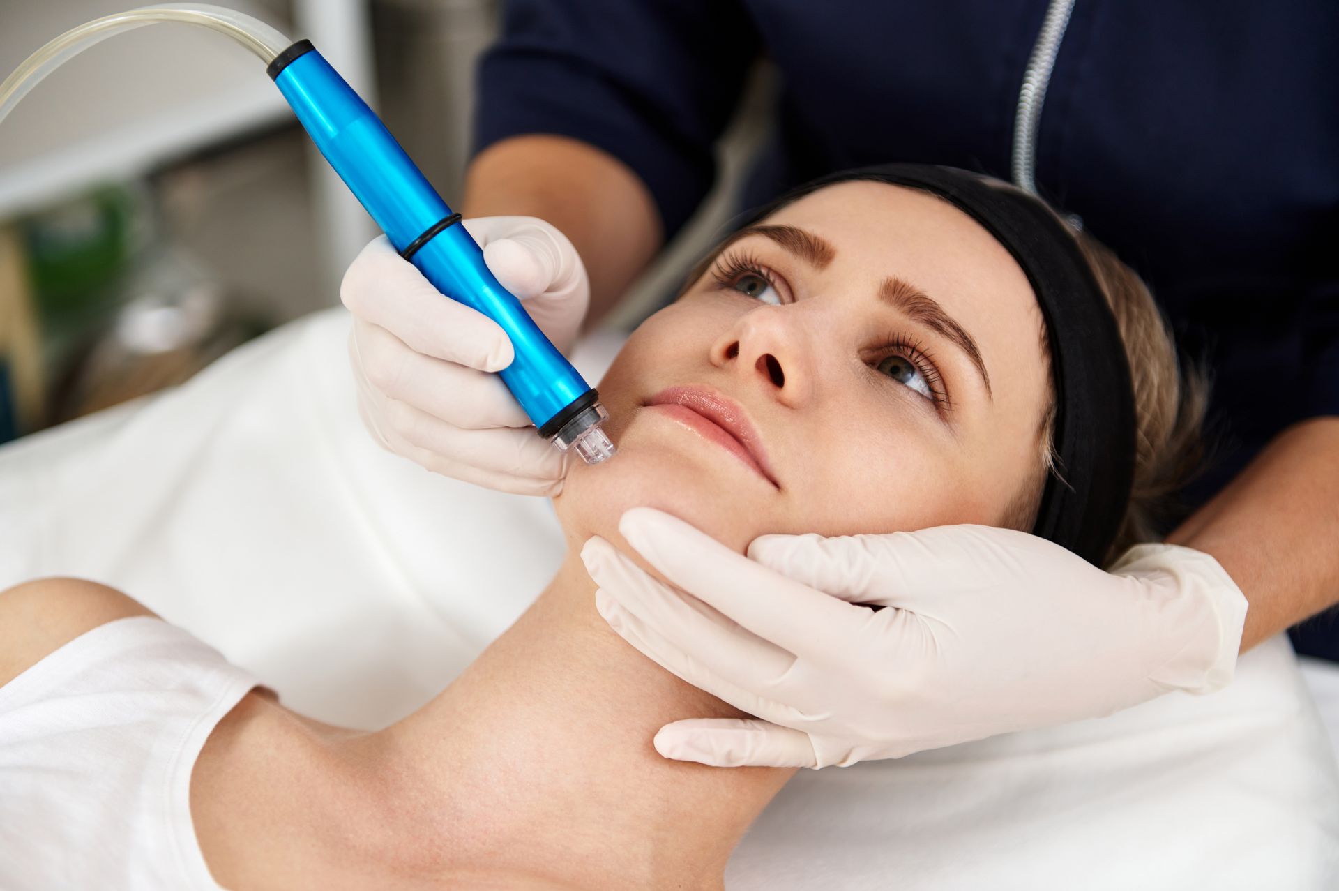 A woman is getting a facial treatment at a beauty salon.