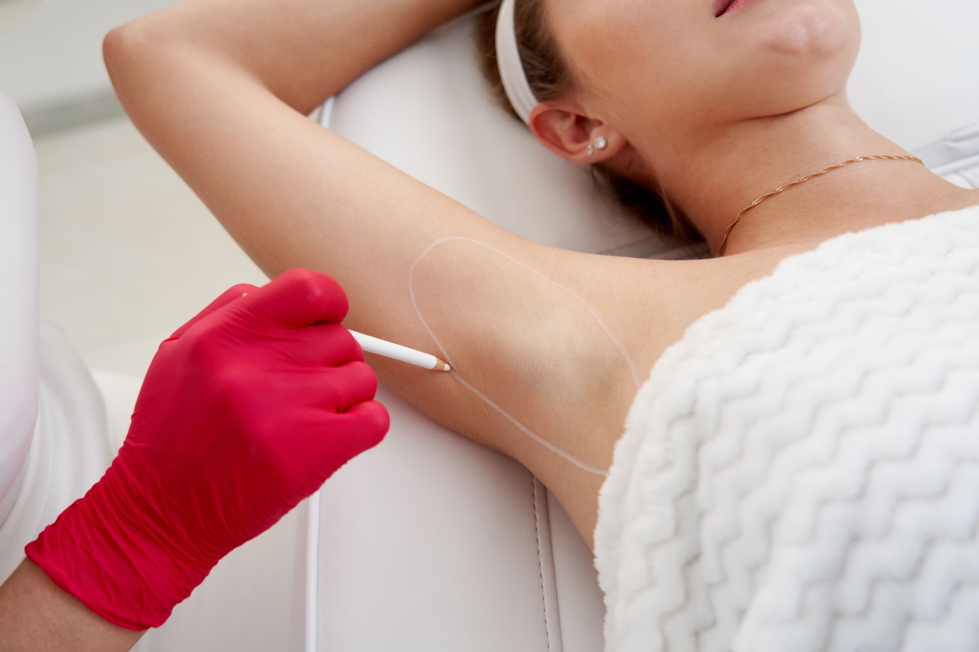 A woman is getting an injection in her armpit.