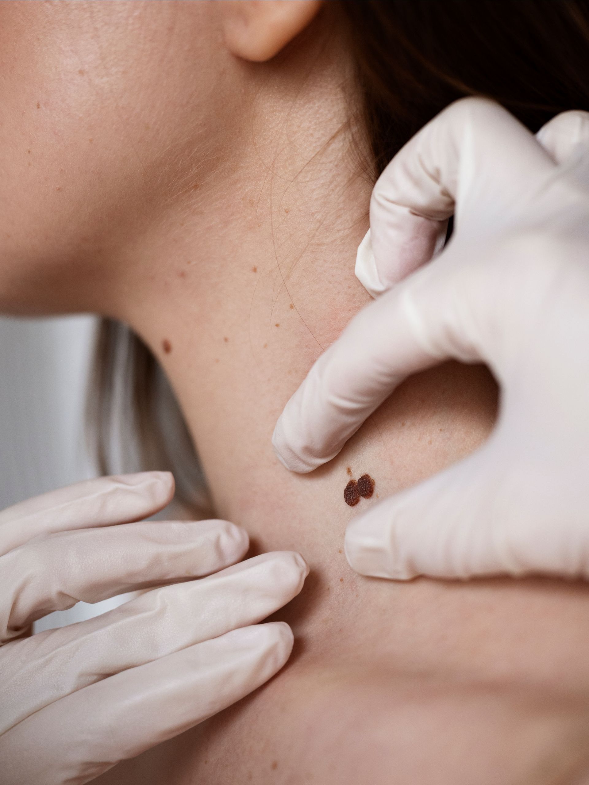 A woman 's neck is being examined by a doctor.