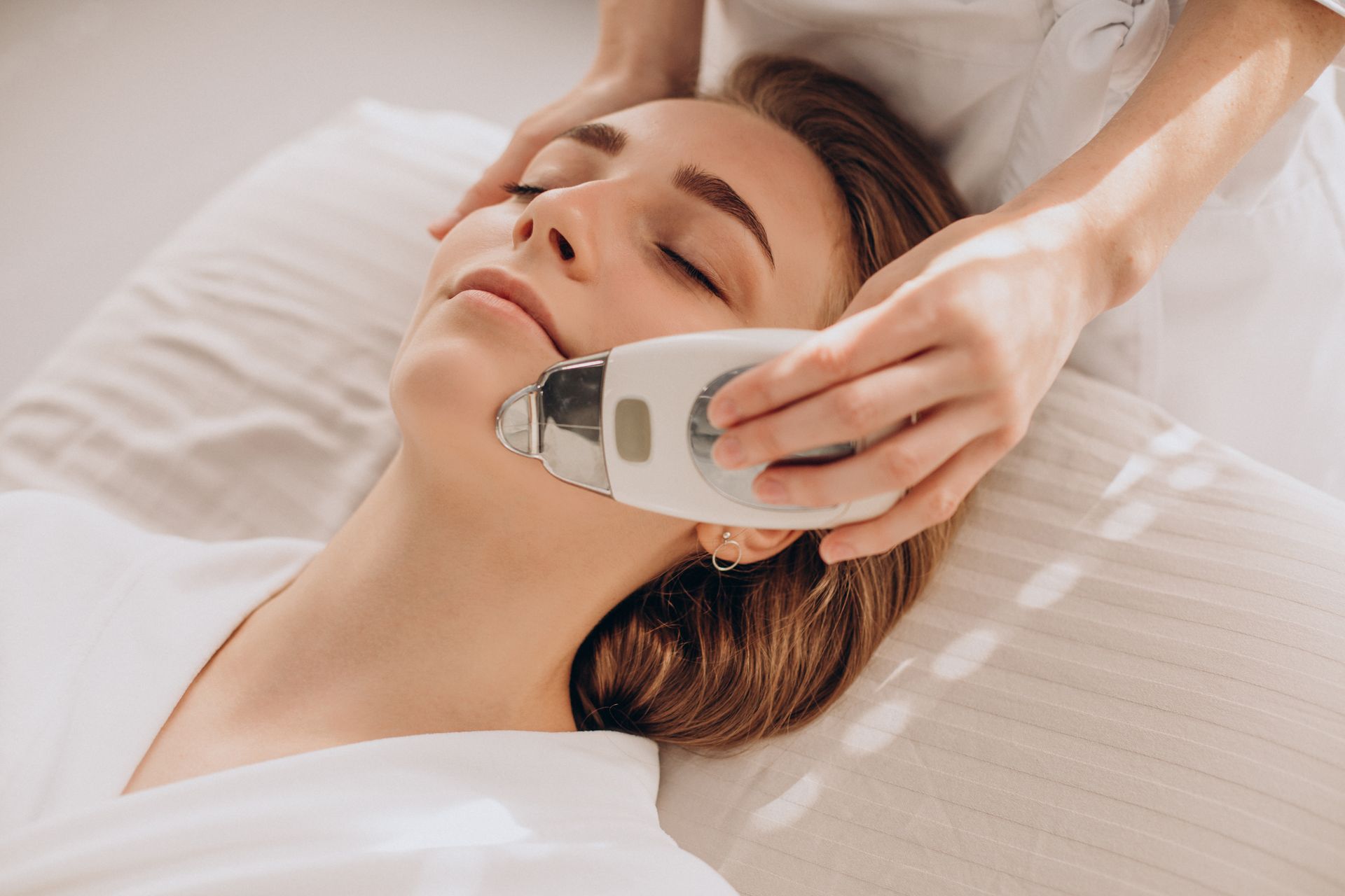 A woman is getting a facial treatment at a beauty salon.