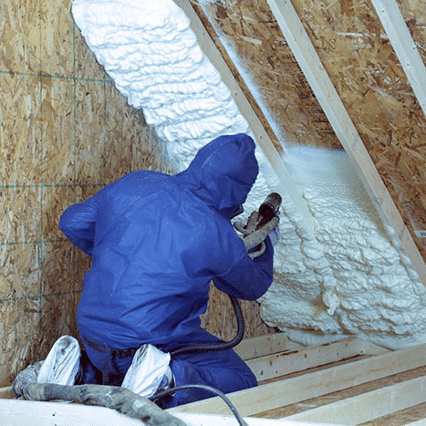 Man Spraying Foam Insulation in Attic  — Freehold, NJ — Top to Bottom Insulation