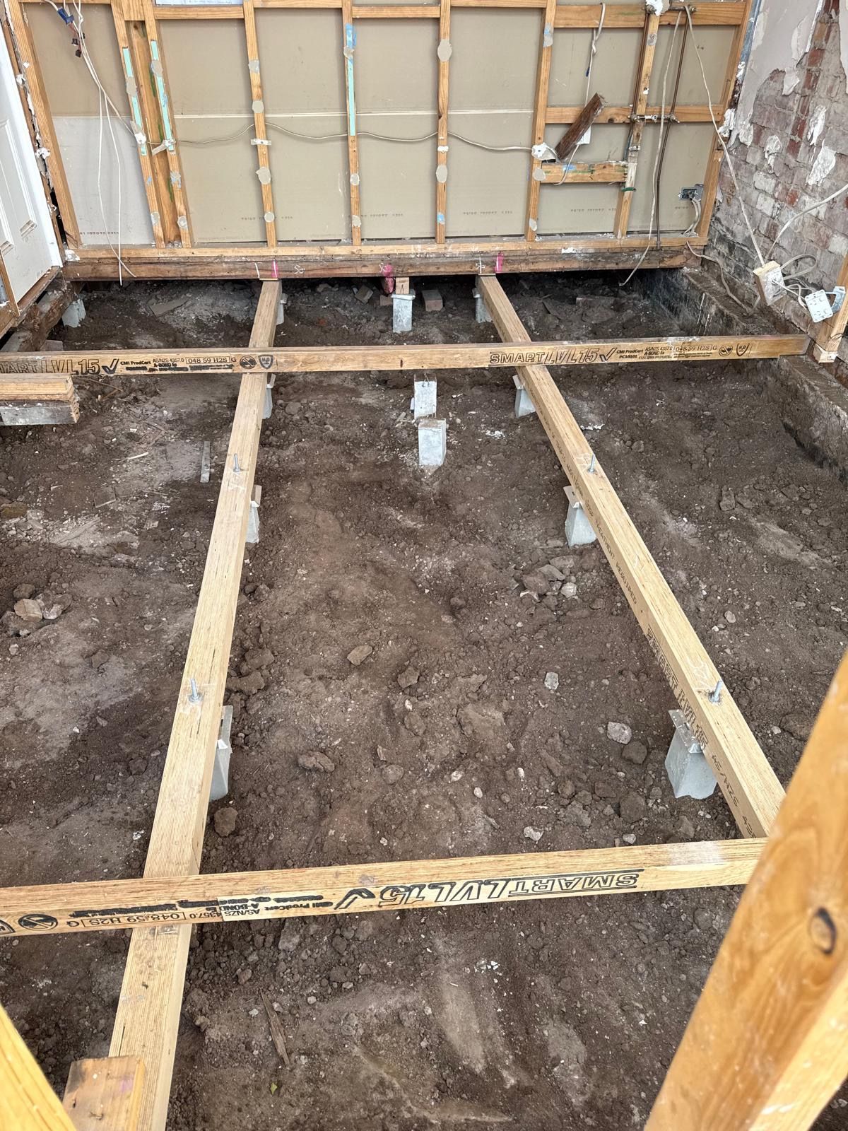 Modern house with gray roof, garage doors, and front door, blue sky background.