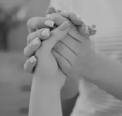 Two hands clasped together in support.