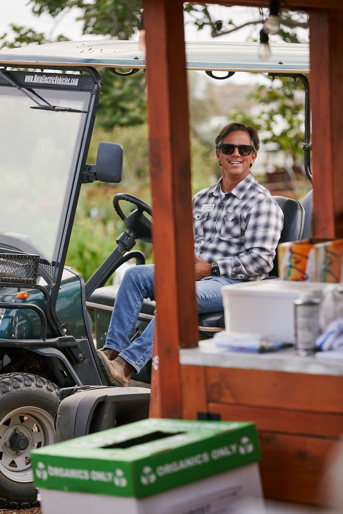 hispanic woman reaching up to pick apples
