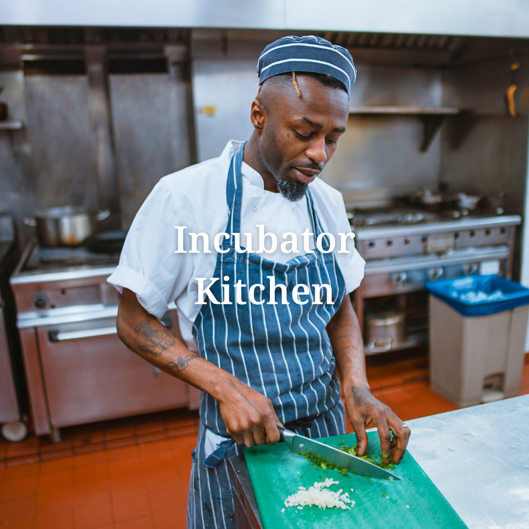 a chef prepares food in an incubator kitchen