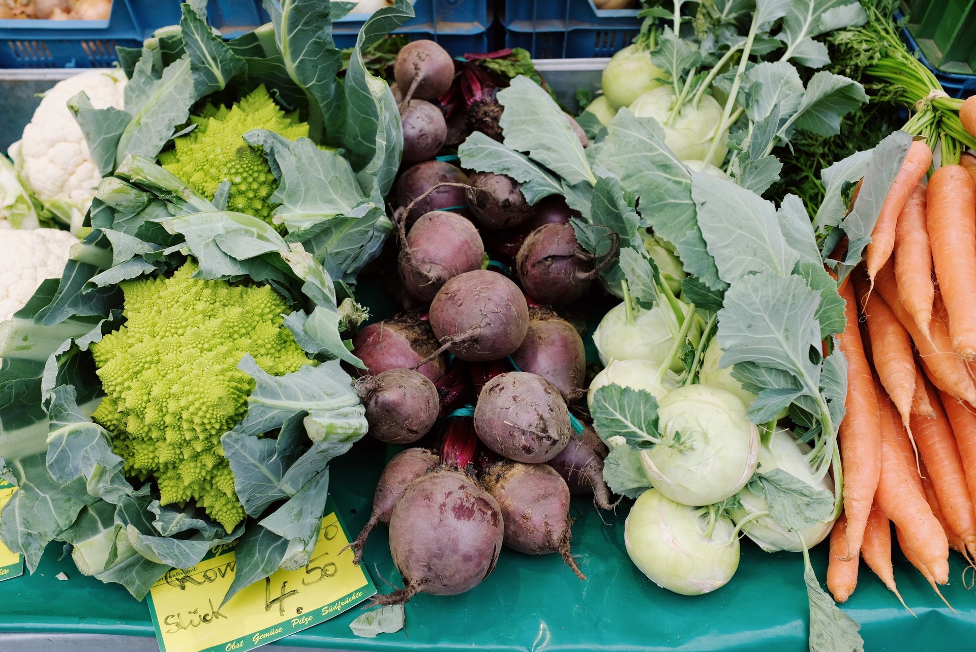 a bunch of vegetables including beets and carrots are on a table