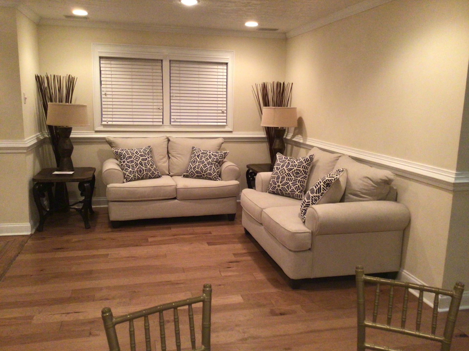 A living room with two couches and two chairs