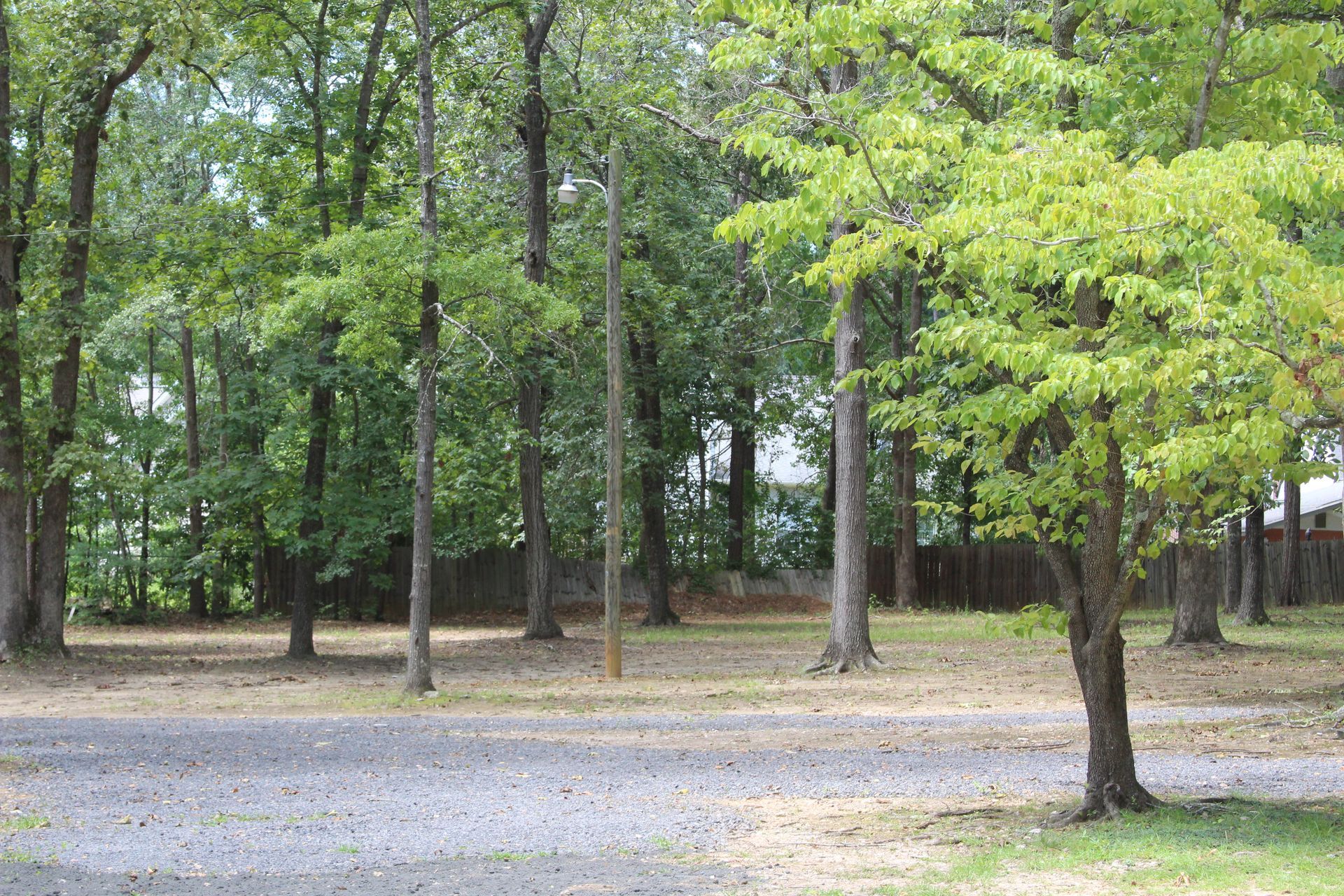 A park with trees and gravel in the middle of it