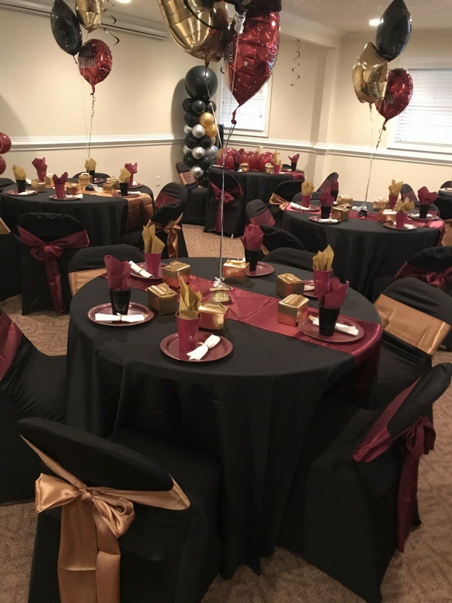A room filled with tables and chairs decorated for a party