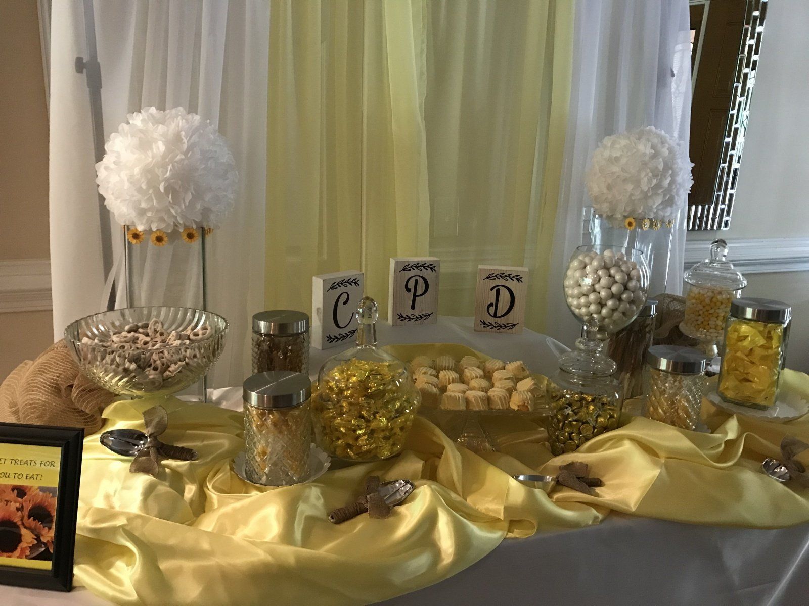 A table filled with candy and a picture of a teddy bear.