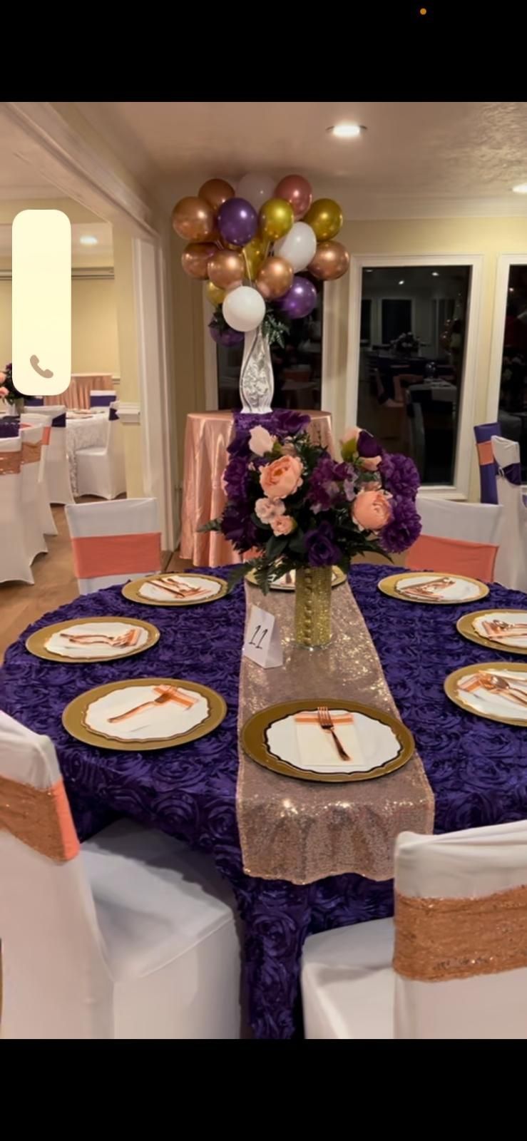 A table set for a party with plates and flowers on it.