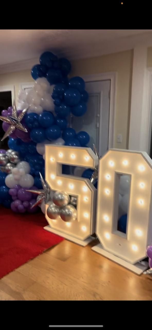 A room with balloons and a sign that says 50