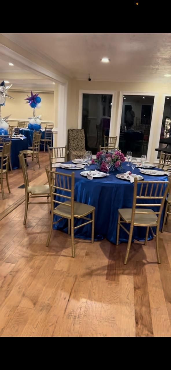 A room with tables and chairs set up for a party.