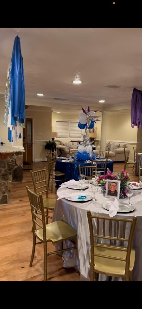 A room with tables and chairs set up for a party.