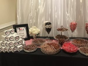 A table topped with a variety of desserts and candy.