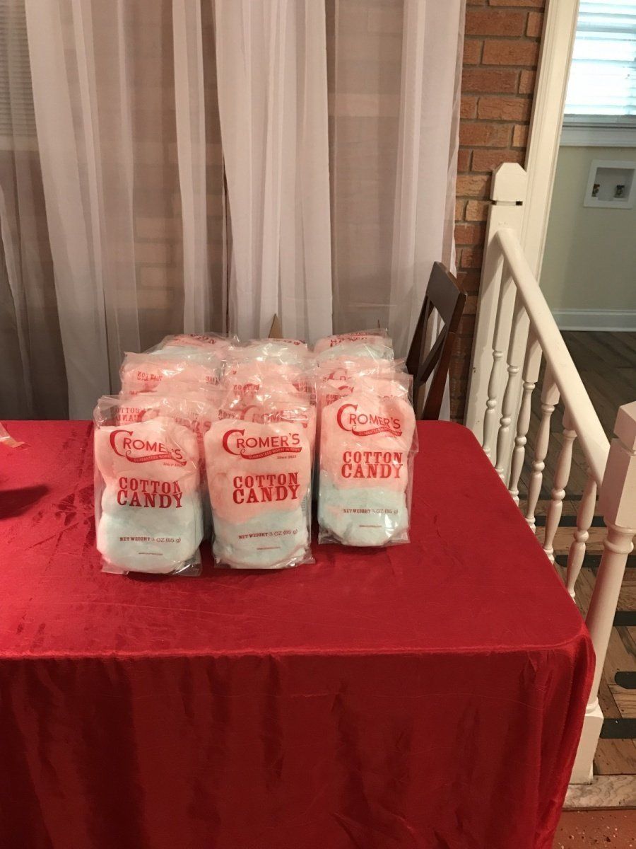 A table with bags of cotton candy on it.