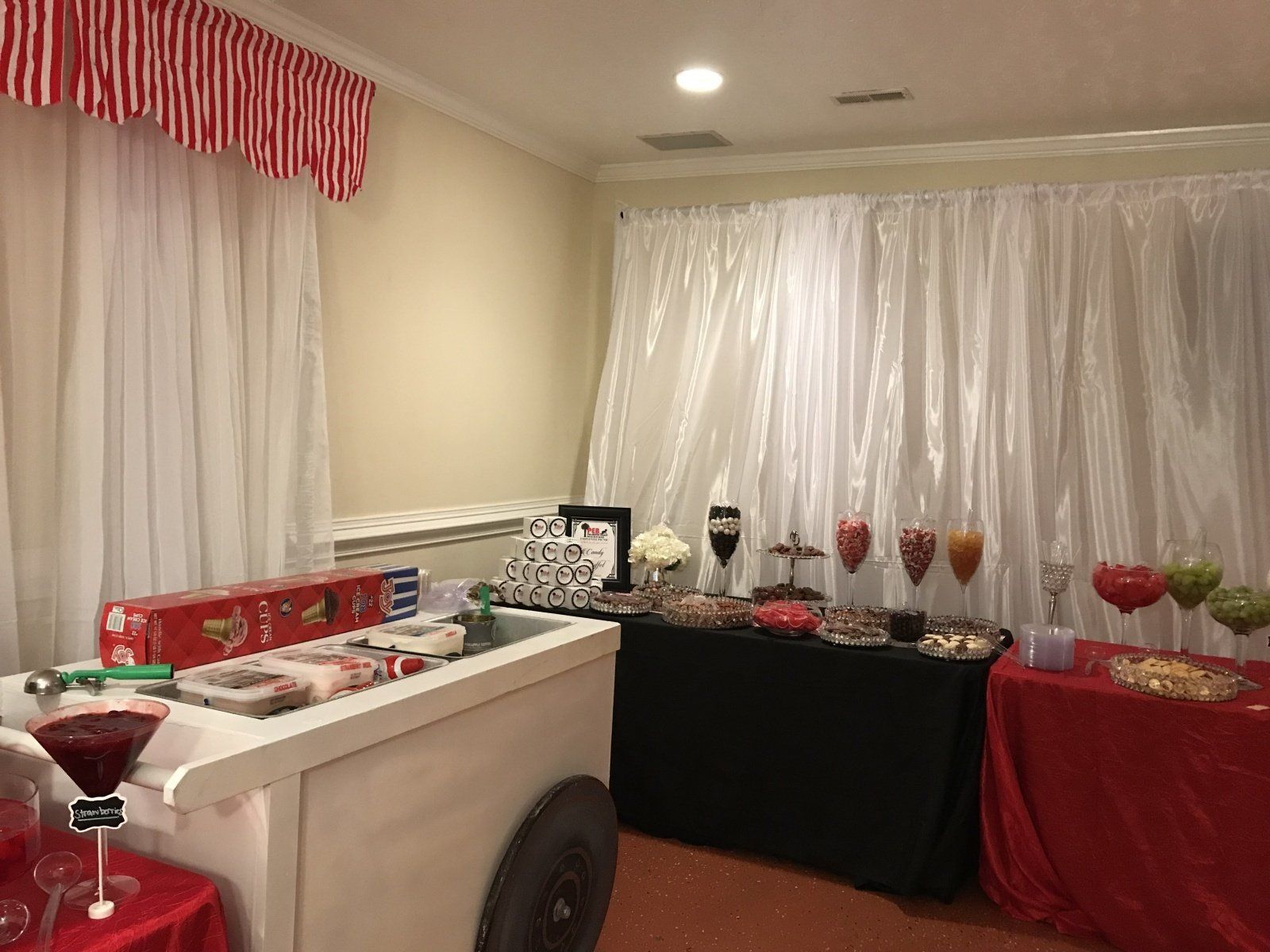 A room filled with tables and a cart with drinks on it.