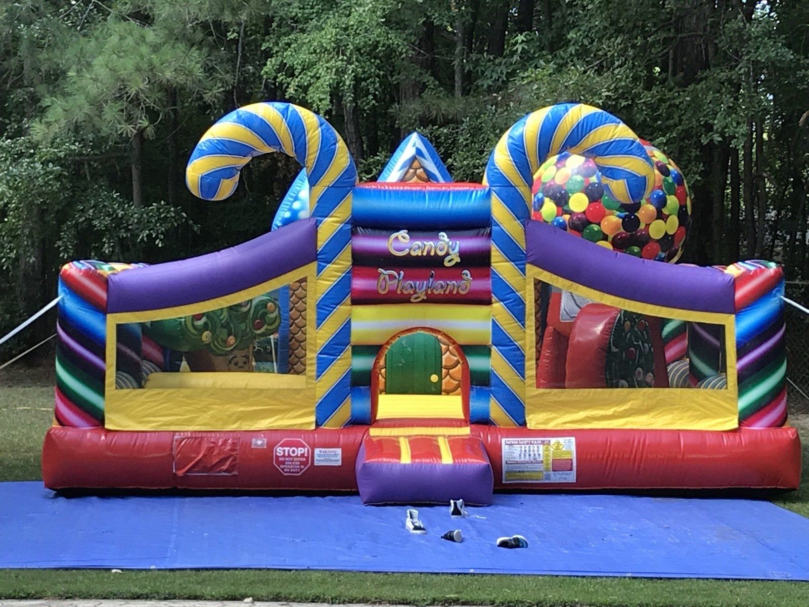 A colorful bouncy house with candy canes on it