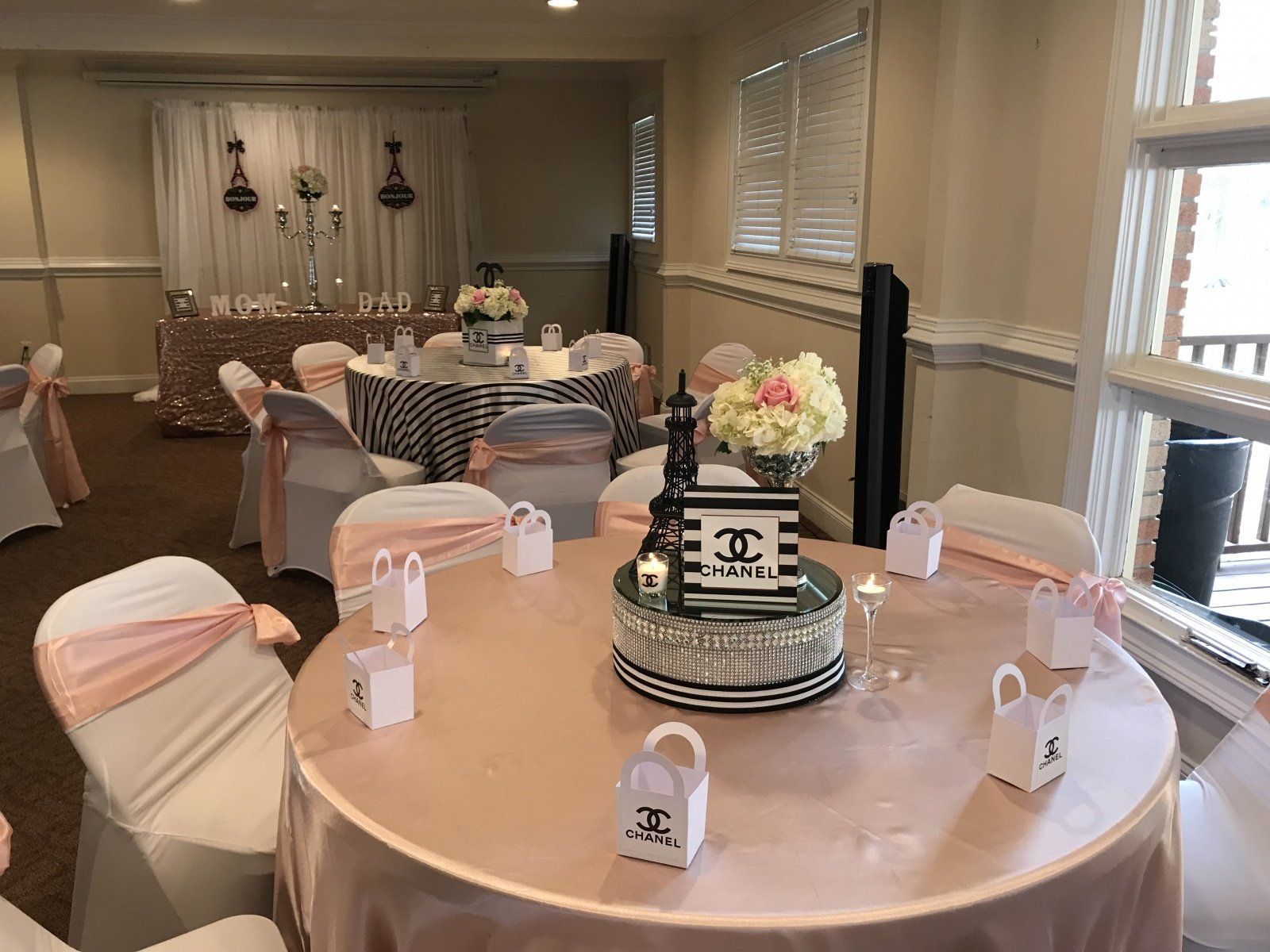 A room with tables and chairs set up for a party.
