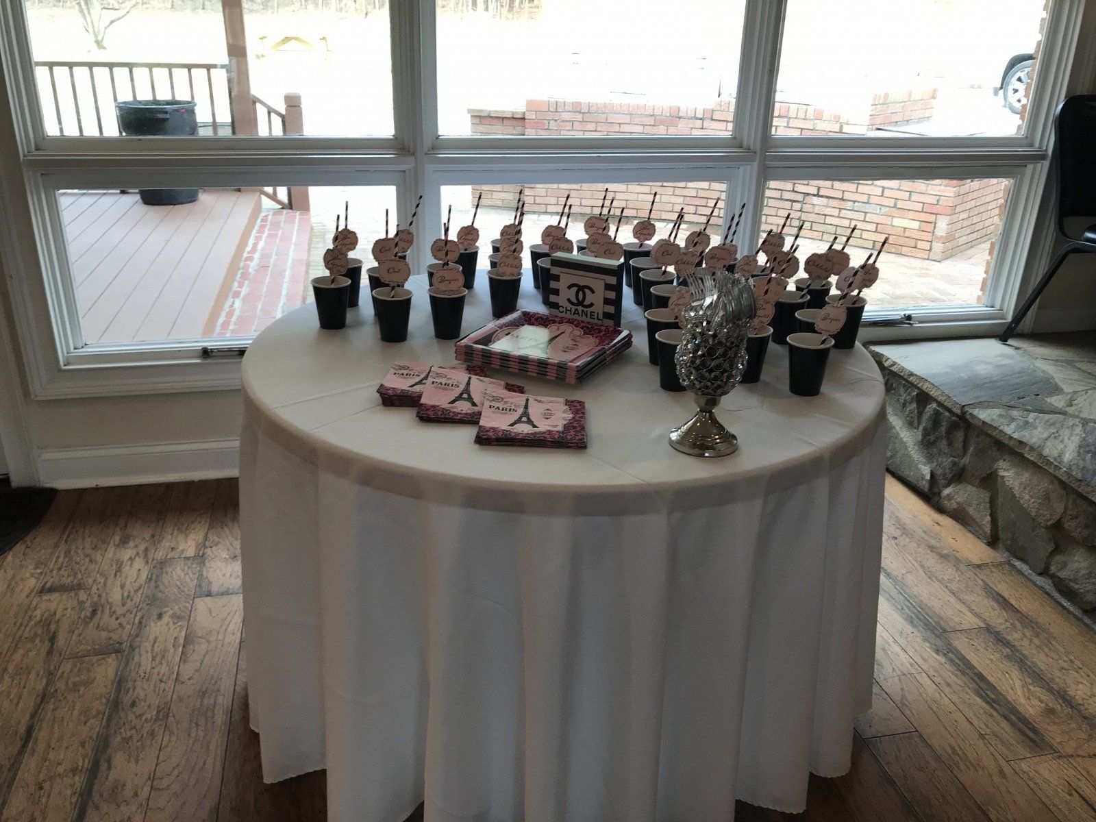 A table with a white table cloth and cupcakes on it