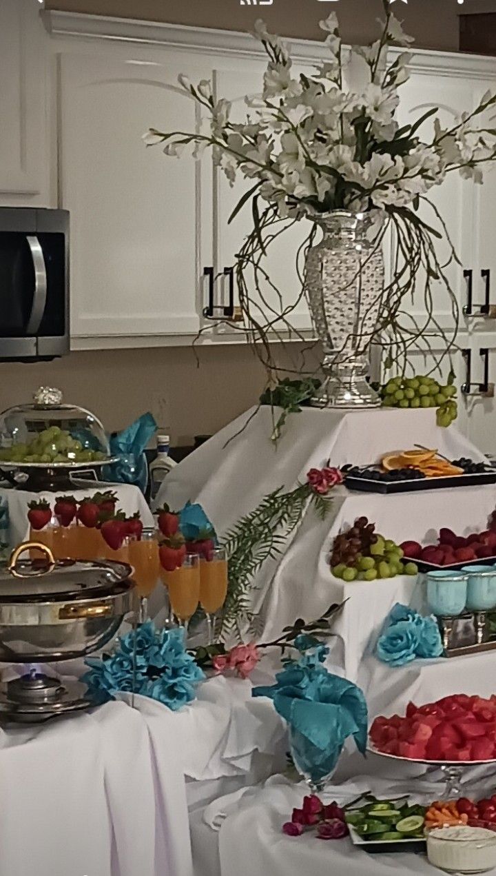 A buffet table with a vase of flowers on top of it