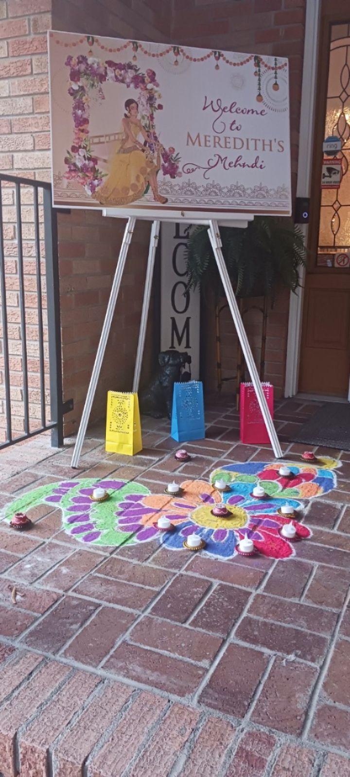 A sign on an easel is sitting on a brick floor.
