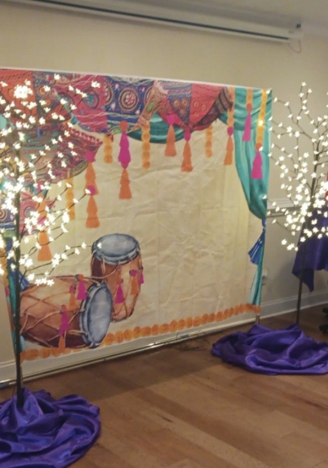 A room with a painting of drums and lights on the floor.