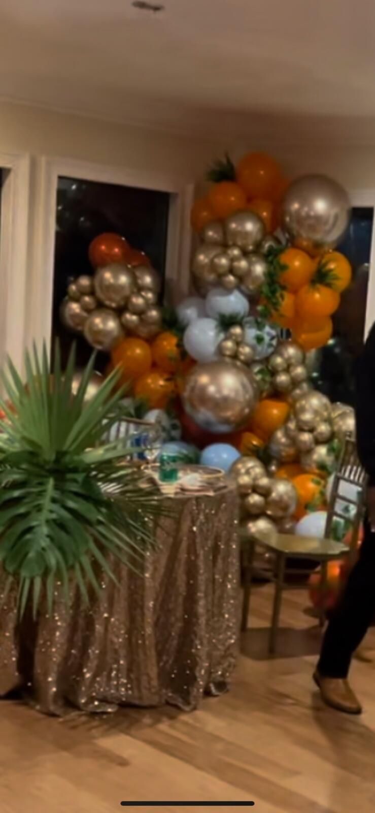 A room filled with lots of balloons and a table.