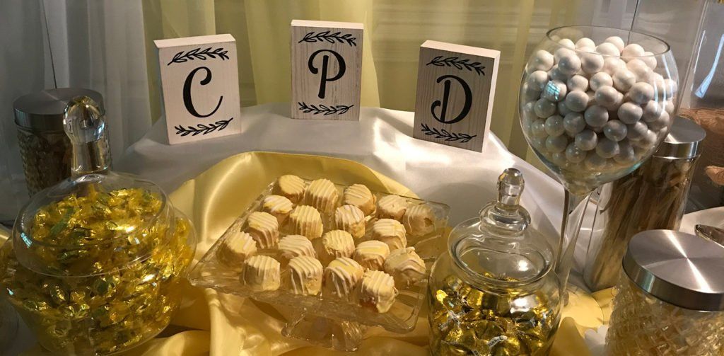 A table with a variety of candy and cupcakes on it.