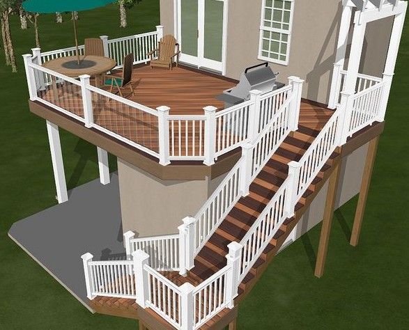 An aerial view of a house with a large deck and stairs leading to it.
