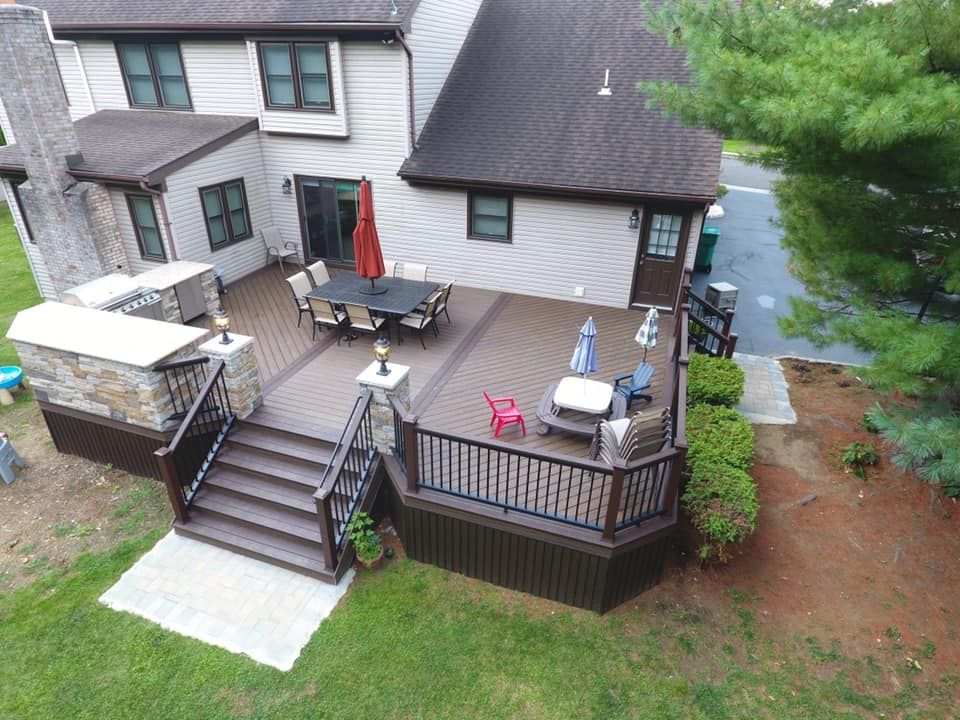 An aerial view of a large deck in front of a house.