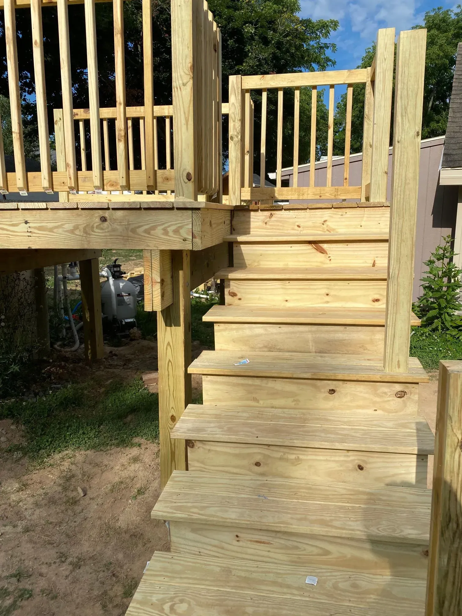 A wooden deck with stairs leading up to it.