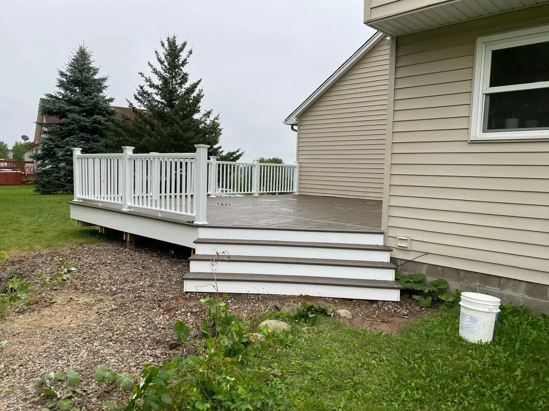 A house with a deck and stairs in front of it