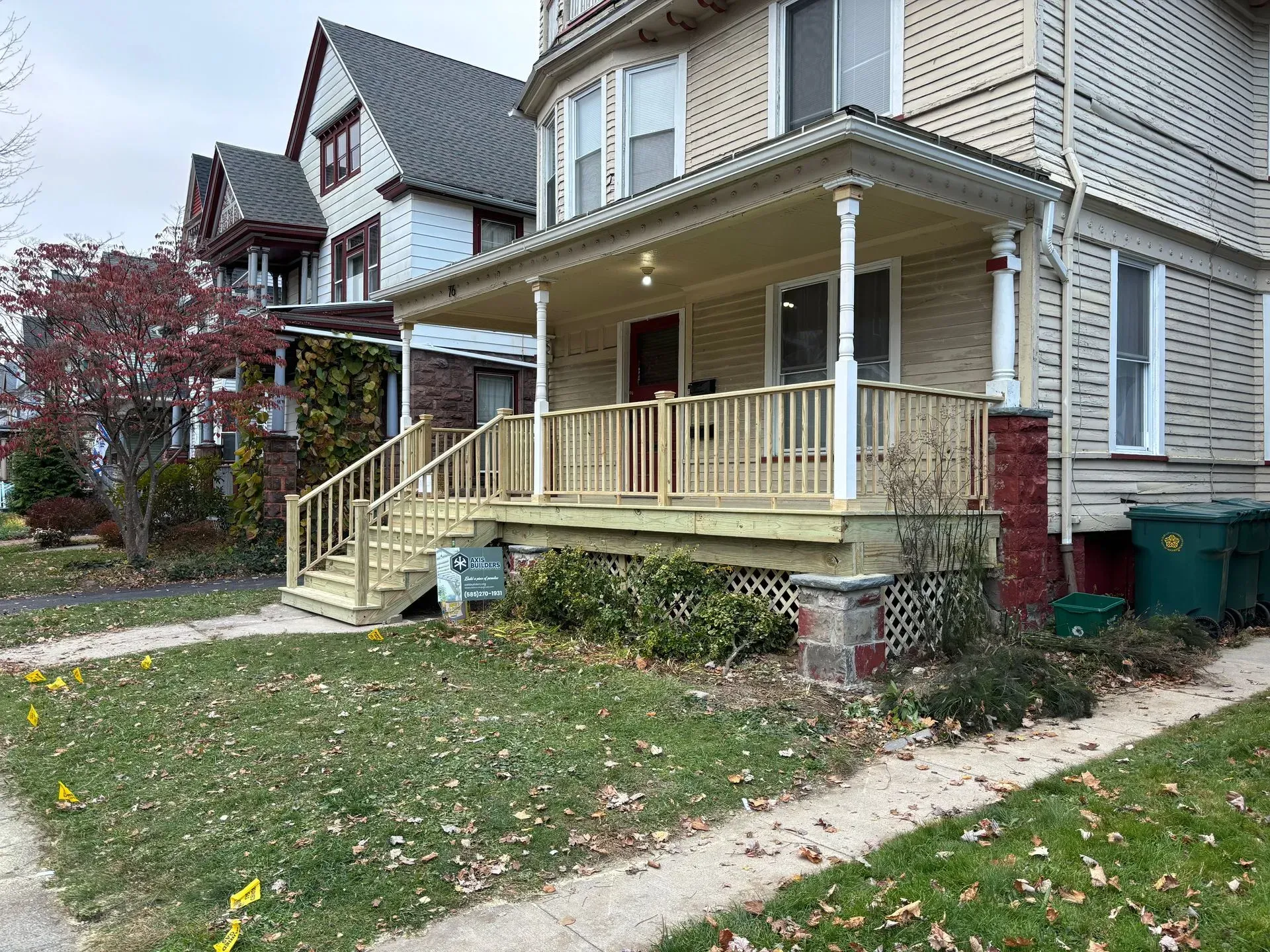 A house with a porch and stairs on the side of it.