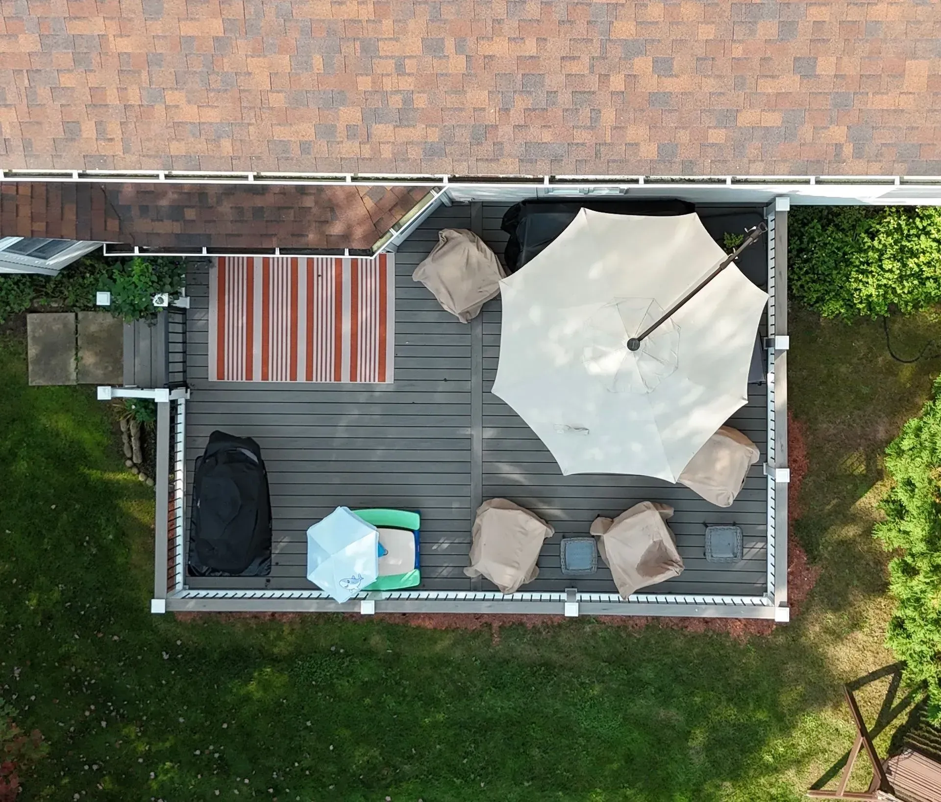 An aerial view of a deck with umbrellas and chairs